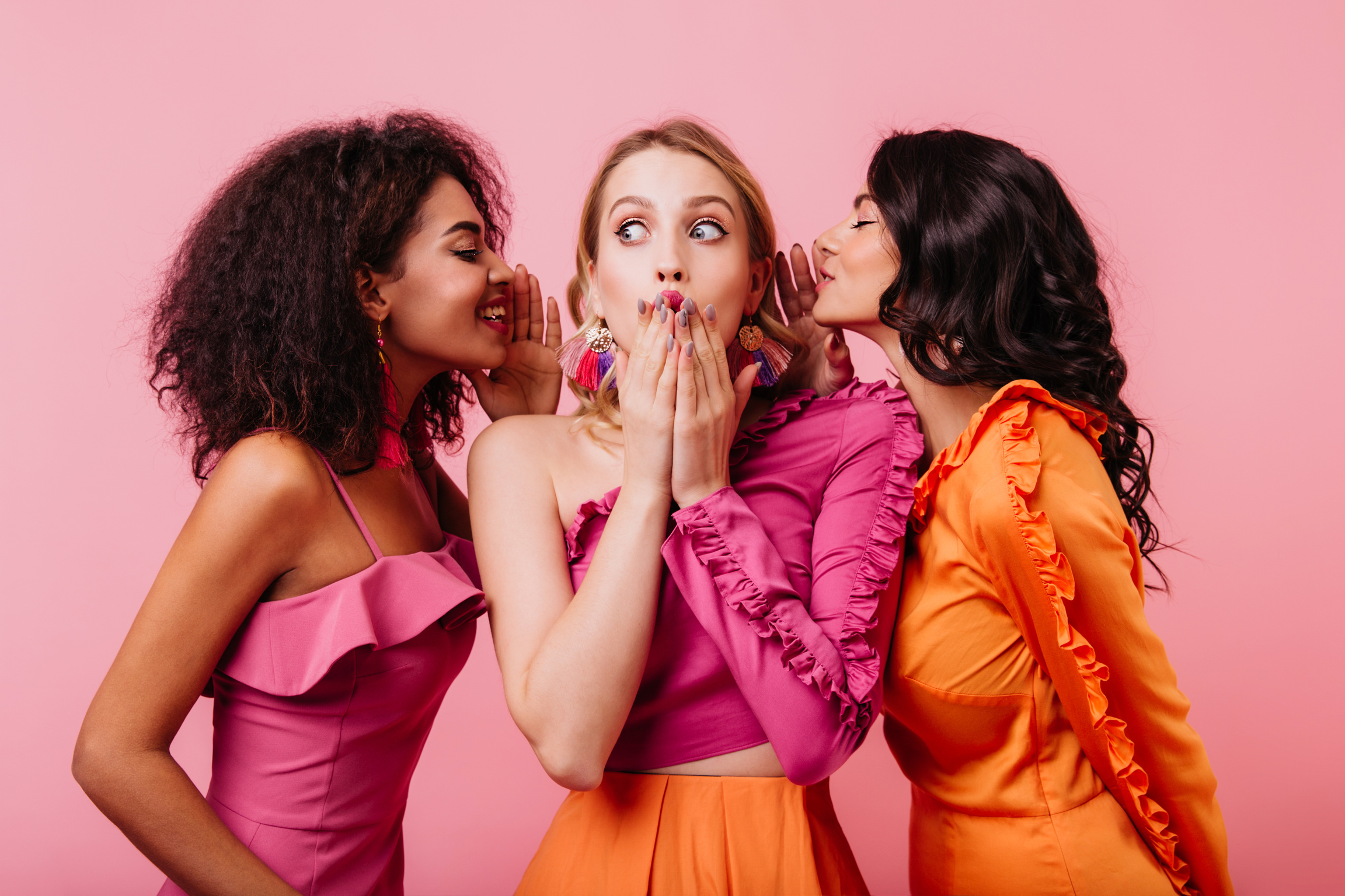 Surprised Blonde Girl Listening Friend's Secrets. Two Brunette Ladies Sharing Rumors with Caucasian Woman